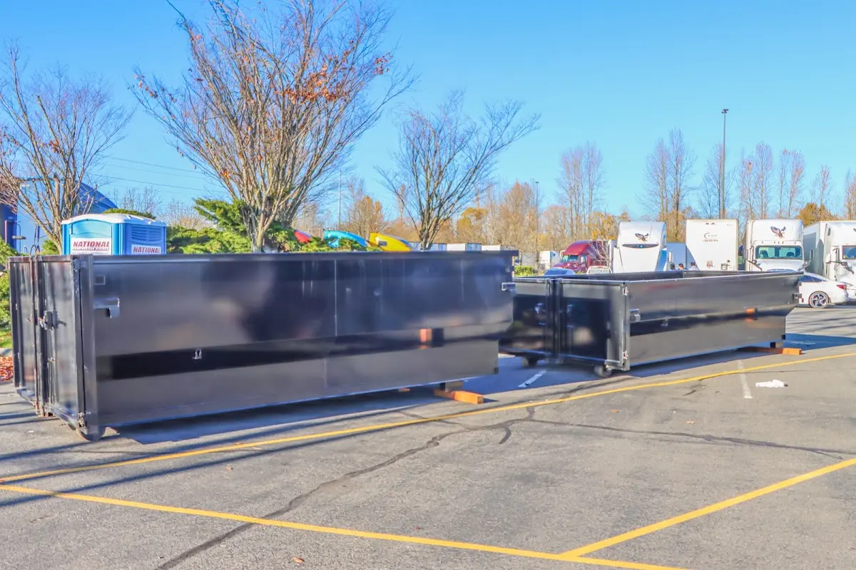 Professional dumpster rental service with roll-off container on residential driveway in West Valley City